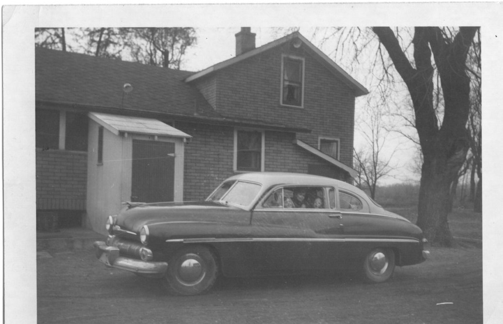 Farmhouse (back side) about 1950 with old car